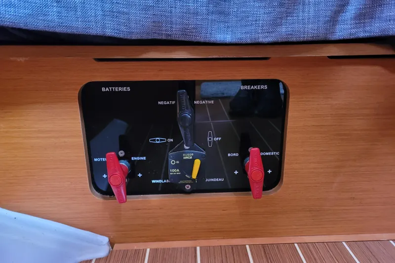 Slide: The Image of Control panel of a 2014 Jeanneau 379 sailboat, featuring battery and breaker switches. - 52
