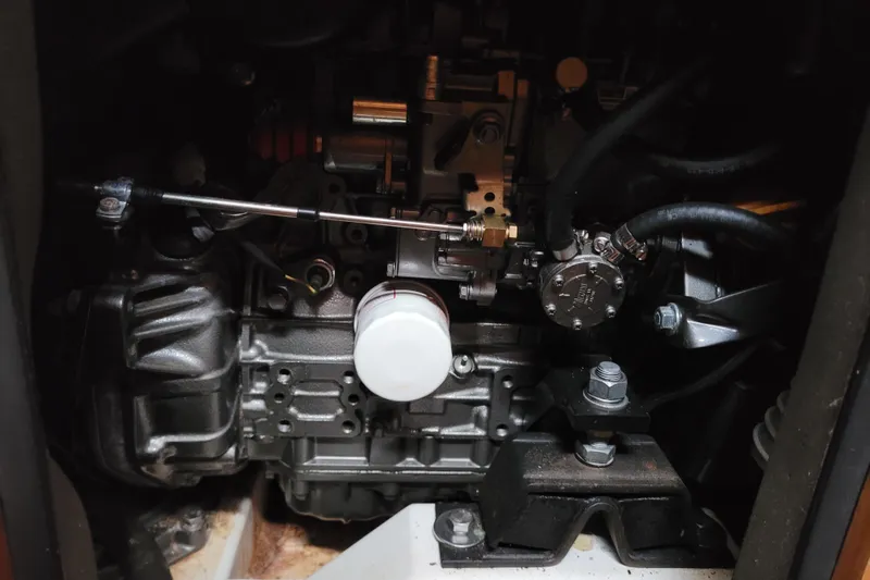 Slide: The Image of Engine compartment of a 2014 Jeanneau 379 sailboat, showcasing mechanical components and hoses. - 54