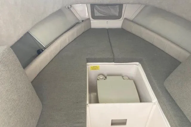 Slide: The Image of 2012 Grady-White Adventure 208 cabin interior with gray upholstery and storage compartment. - 10