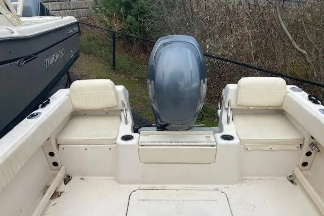Slide: The Image of 2012 Grady-White Adventure 208 boat interior with seating and outboard motor. - 13