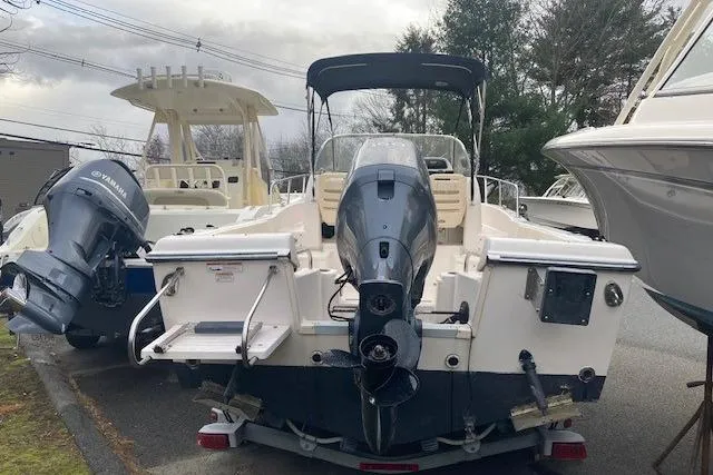 Slide: The Image of 2012 Grady-White Adventure 208 boat with Yamaha outboard motor, parked outdoors. - 4