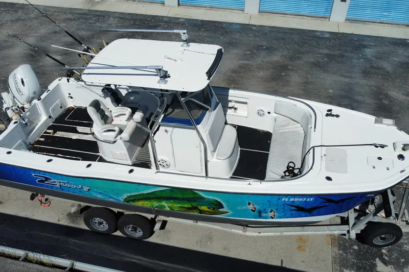 Slide: The Image of 2002 ProKat 2660 Center Console boat on trailer, featuring vibrant marine graphics. - 13