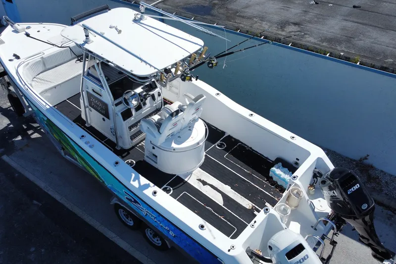 Slide: The Image of 2002 ProKat 2660 Center Console boat with dual engines and fishing gear. - 20