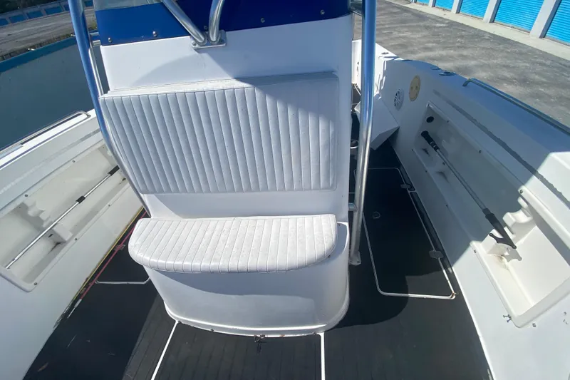 Slide: The Image of 2002 ProKat 2660 Center Console boat interior with seating and storage compartments. - 33