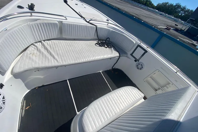 Slide: The Image of 2002 ProKat 2660 Center Console boat interior with white seating and black flooring. - 34