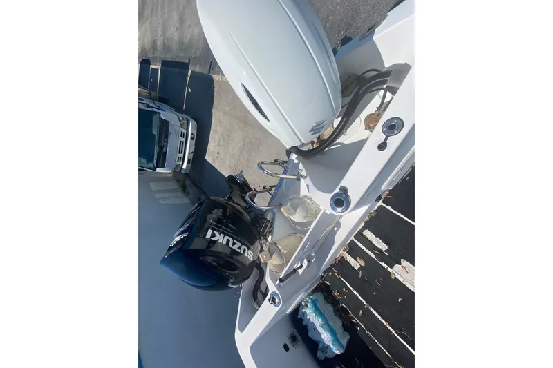 Slide: The Image of 2002 ProKat 2660 Center Console with Suzuki outboard motor, docked on a sunny day. - 39