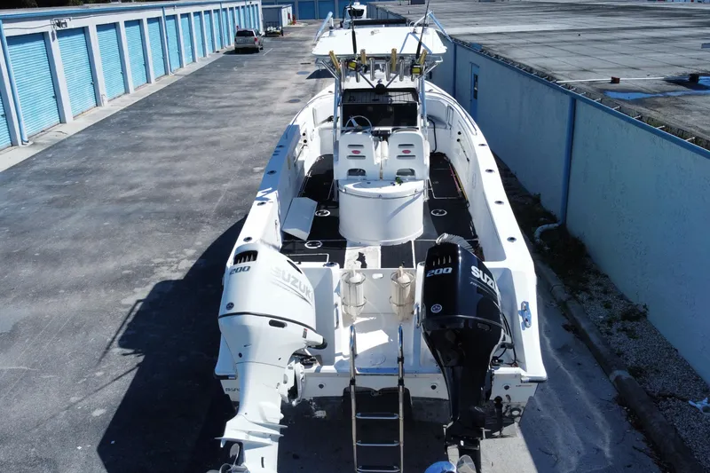 Slide: The Image of 2002 ProKat 2660 Center Console boat with dual Suzuki engines in storage facility. - 46