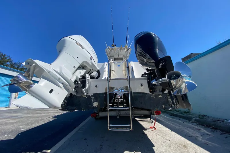 Slide: The Image of 2002 ProKat 2660 Center Console boat with dual outboard motors, rear view. - 48