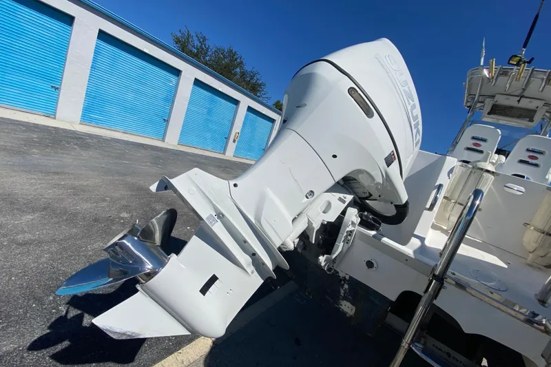 Slide: The Image of 2002 ProKat 2660 Center Console boat with Suzuki outboard motor in storage facility. - 51