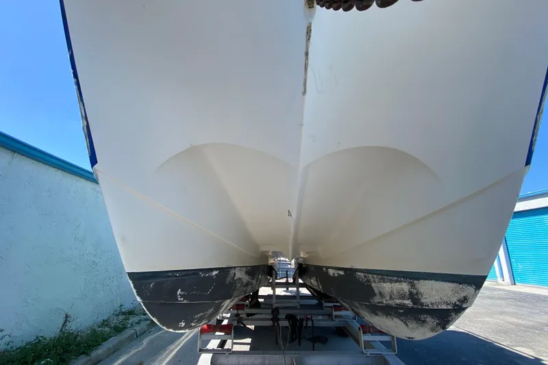 Slide: The Image of 2002 ProKat 2660 Center Console boat hull on trailer, viewed from below. - 57