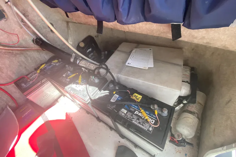 Slide: The Image of Battery compartment of a 2002 ProKat 2660 Center Console boat, featuring AGM and DieHard batteries. - 58