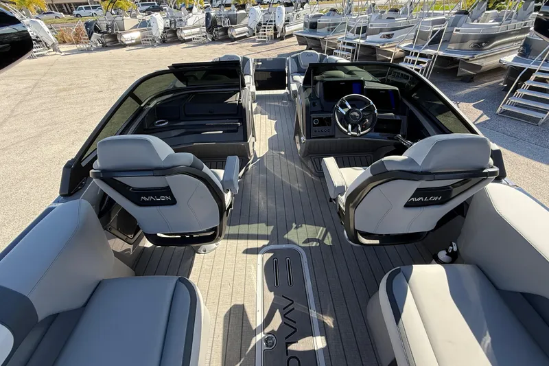 Slide: The Image of 2026 Avalon 2585 Excalibur boat interior with quad loungers and modern dashboard. - 13