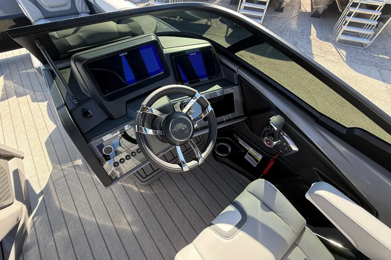 Slide: The Image of 2026 Avalon 2585 Excalibur boat dashboard with modern controls and steering wheel. - 23