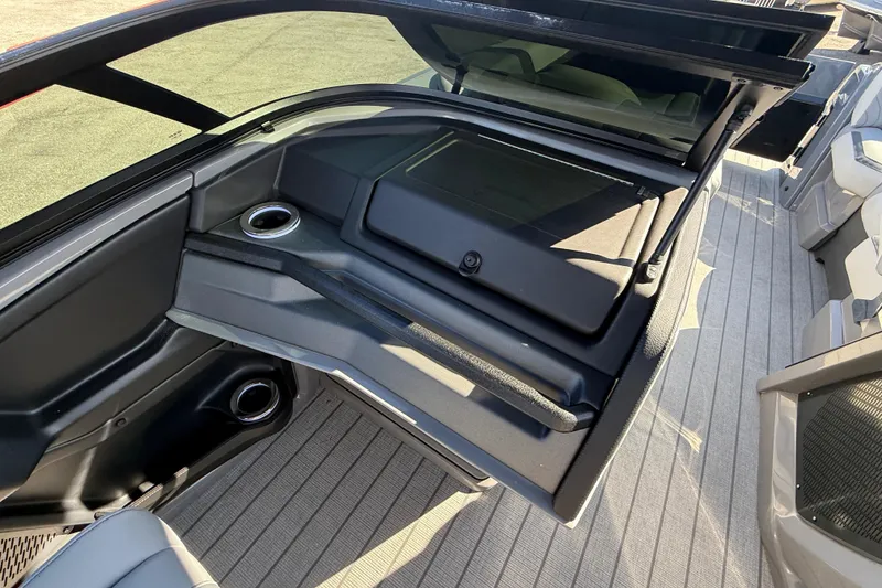 Slide: The Image of 2026 Avalon 2585 Excalibur boat interior with sleek design and cup holders. - 25