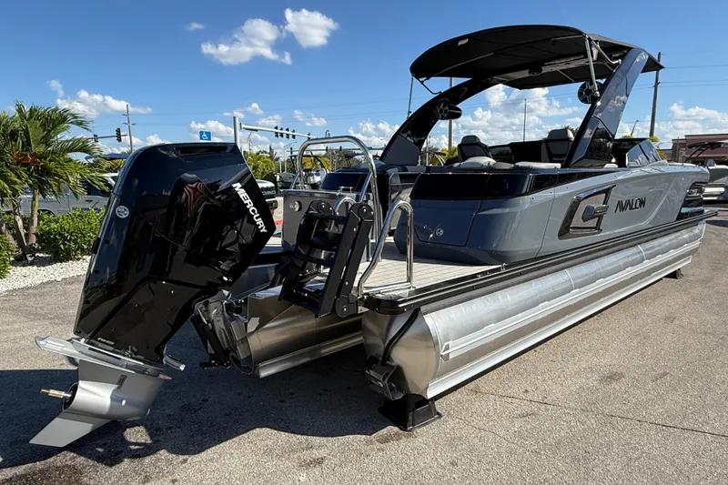 Slide: The Image of 2026 Avalon 2585 Excalibur boat with Mercury 400hp V-10 engine, parked outdoors. - 5