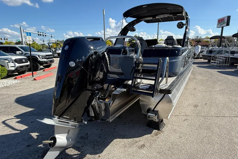 Slide: The Image of 2026 Avalon 2585 Excalibur boat with Mercury 400hp V-10 engine, parked outdoors. - 6