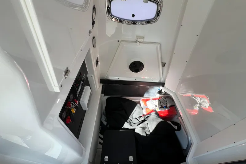 Slide: The Image of Interior cabin of 2023 Blackfin 272 boat, featuring control panel and storage area. - 22
