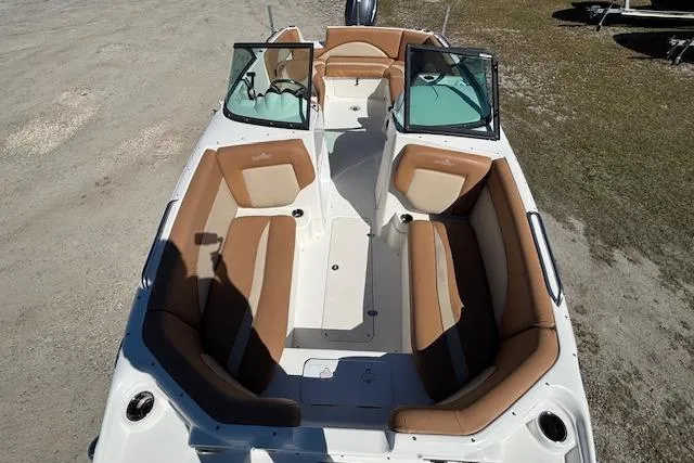 Slide: The Image of 2016 NauticStar 223 DC boat with tan seating and open deck layout. - 11