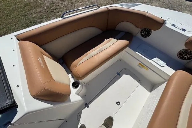 Slide: The Image of 2016 NauticStar 223 DC boat interior with tan seating and cup holders. - 12