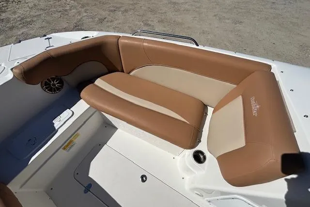Slide: The Image of 2016 NauticStar 223 DC boat interior with tan seating and speaker. - 13
