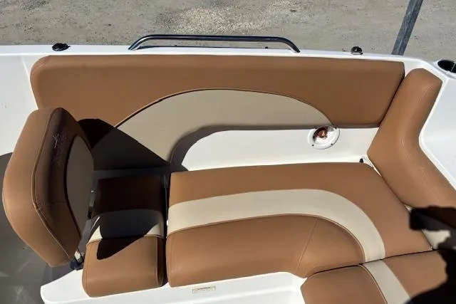 Slide: The Image of 2016 NauticStar 223 DC boat interior with tan and cream seating. - 15