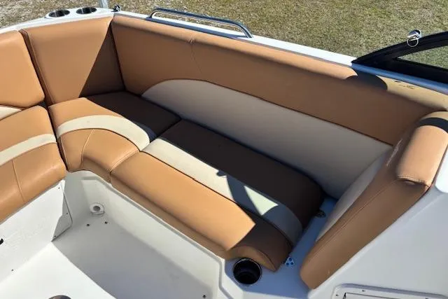 Slide: The Image of 2016 NauticStar 223 DC boat interior with tan and cream seating. - 17