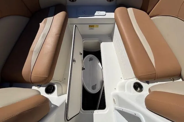 Slide: The Image of 2016 NauticStar 223 DC boat interior with tan seating and storage compartment. - 19