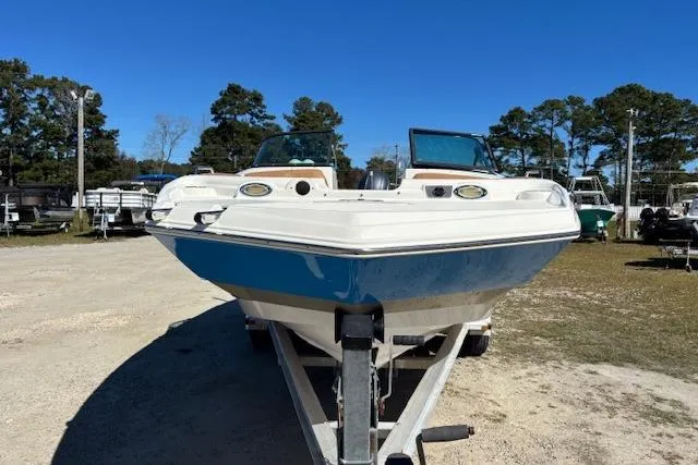 Slide: The Image of 2016 NauticStar 223 DC boat on trailer in outdoor storage area. - 2