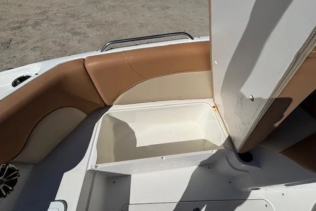 Slide: The Image of 2016 NauticStar 223 DC boat interior with tan seating and storage compartment. - 20