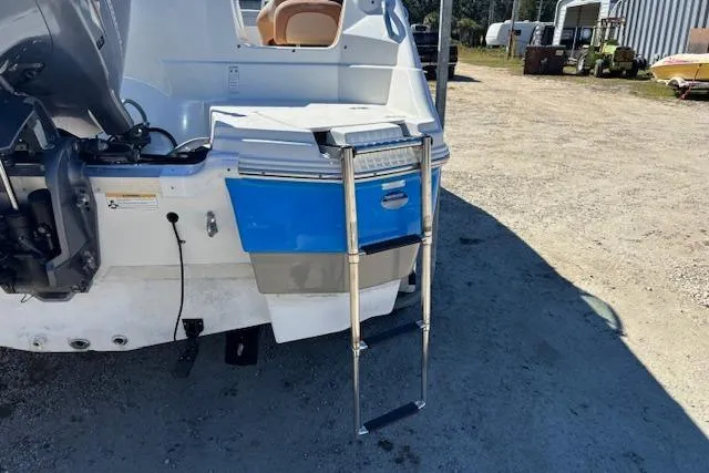 Slide: The Image of 2016 NauticStar 223 DC boat with extended swim ladder on a sunny day. - 22