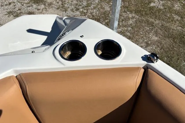 Slide: The Image of 2016 NauticStar 223 DC boat interior with tan seating and dual cup holders. - 28