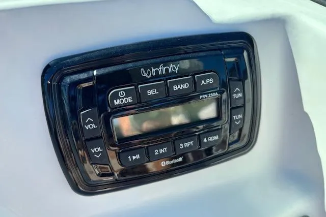 Slide: The Image of Infinity stereo system on 2016 NauticStar 223 DC boat dashboard. - 32