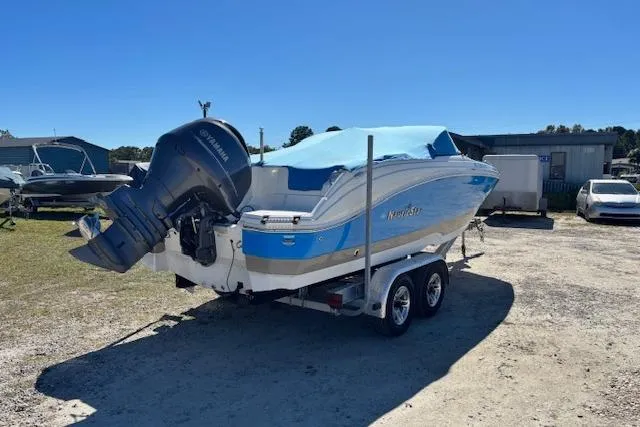 Slide: The Image of 2016 NauticStar 223 DC boat on trailer with blue cover and Yamaha outboard motor. - 38