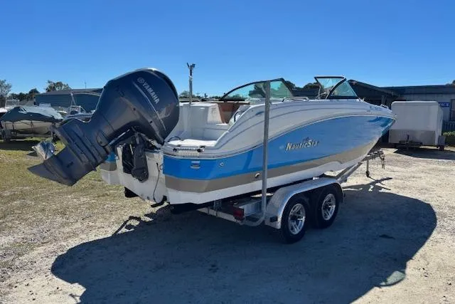 Slide: The Image of 2016 NauticStar 223 DC boat on trailer with Yamaha outboard motor, parked outdoors. - 5