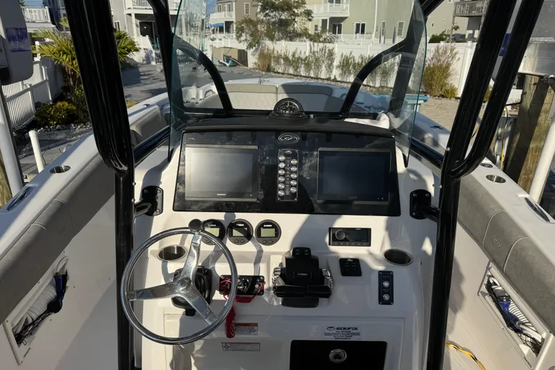 Slide: The Image of 2023 Sea Fox 268 Commander boat dashboard with steering wheel and navigation screens. - 28