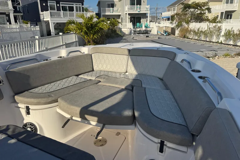 Slide: The Image of 2023 Sea Fox 268 Commander boat with spacious, cushioned seating area in a coastal setting. - 31