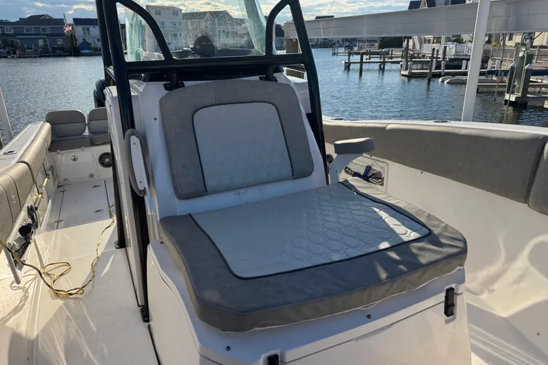Slide: The Image of 2023 Sea Fox 268 Commander boat interior with cushioned seating, dockside view. - 33