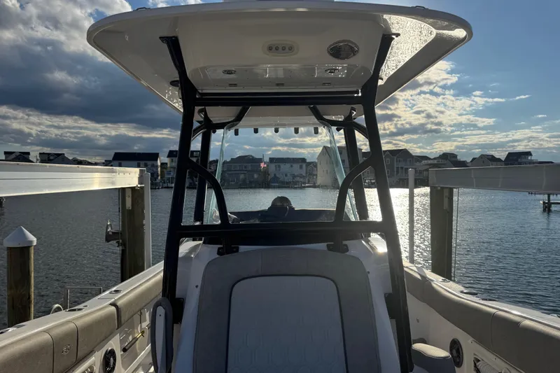 Slide: The Image of 2023 Sea Fox 268 Commander boat docked, with scenic waterfront view and cloudy sky. - 35