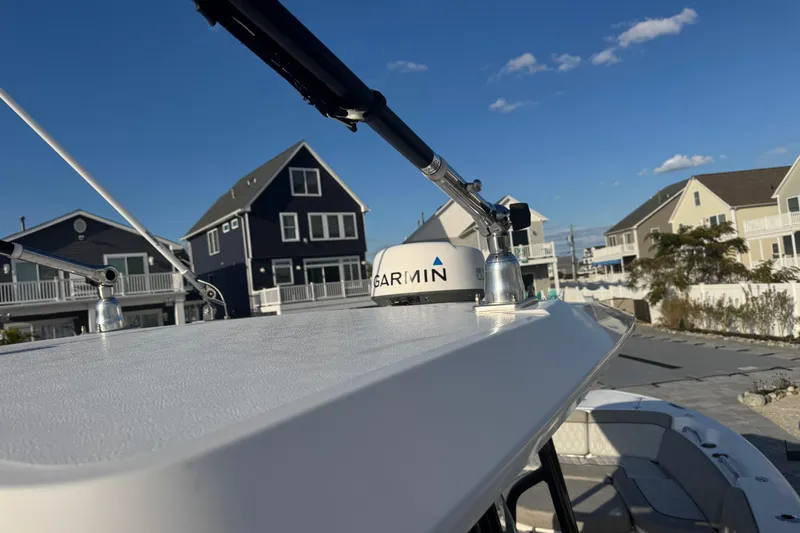 Slide: The Image of 2023 Sea Fox 268 Commander boat with Garmin equipment, docked near coastal homes. - 36