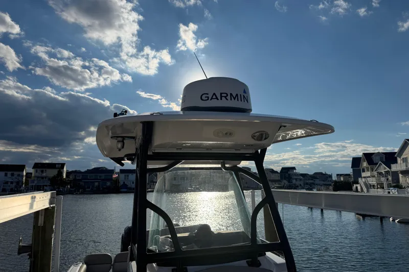 Slide: The Image of 2023 Sea Fox 268 Commander boat with Garmin equipment, docked under a partly cloudy sky. - 37