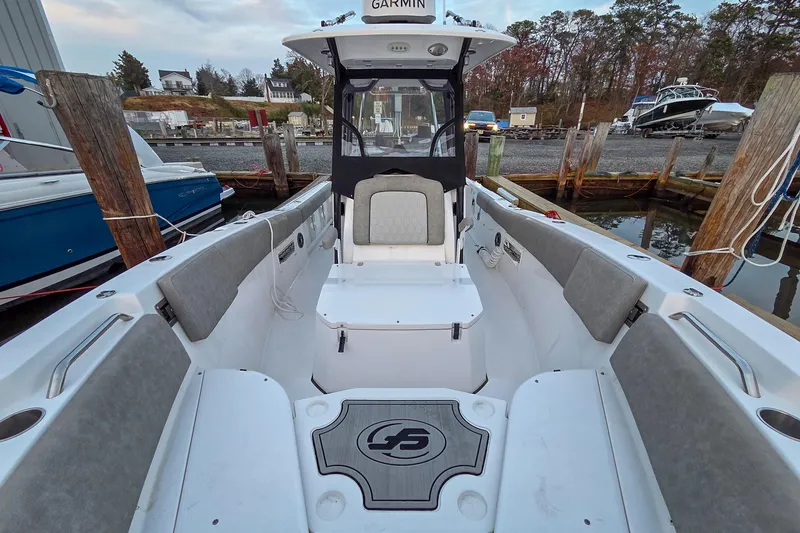 Slide: The Image of 2023 Sea Fox 268 Commander boat interior with seating and Garmin equipment at a dock. - 42