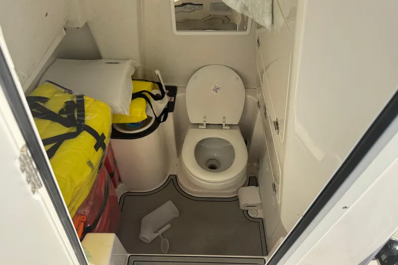 Slide: The Image of 2023 Sea Fox 268 Commander boat bathroom with toilet and storage. - 44