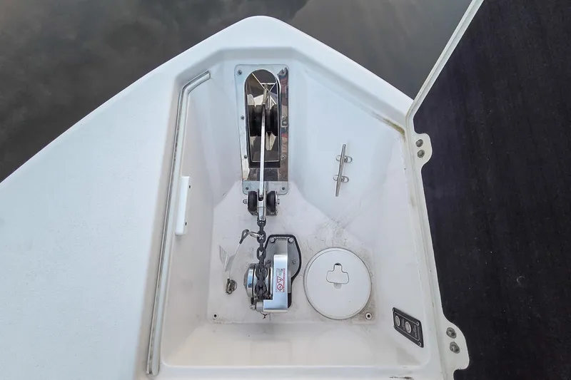 Slide: The Image of Anchor compartment of 2023 Sea Fox 268 Commander boat, featuring a winch and chain. - 45