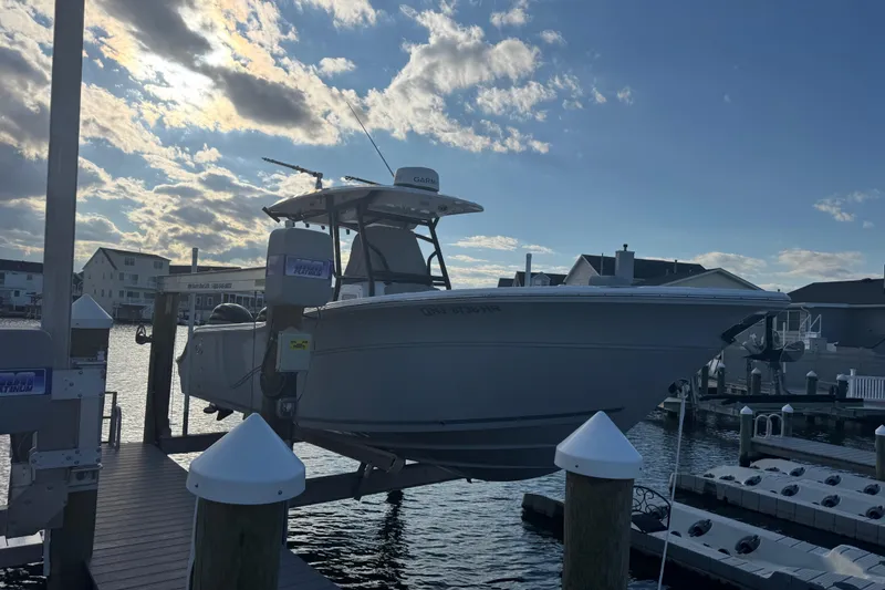 Slide: The Image of 2023 Sea Fox 268 Commander boat docked at marina under cloudy sky. - 5