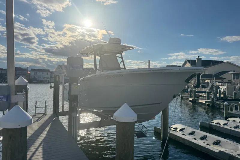 Slide: The Image of 2023 Sea Fox 268 Commander boat docked at marina under a cloudy sky. - 6