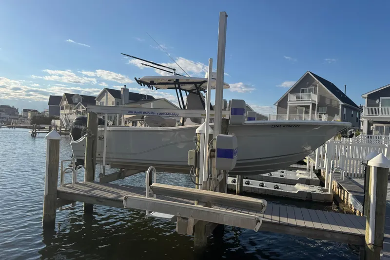 Slide: The Image of 2023 Sea Fox 268 Commander boat docked at marina under sunny sky. - 7