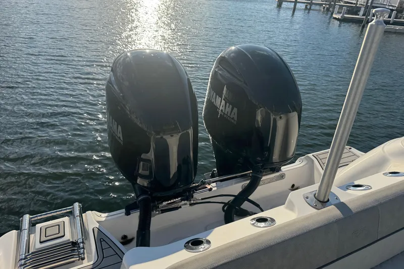 Slide: The Image of 2023 Sea Fox 268 Commander boat docked at a marina with waterfront homes in the background. - 8