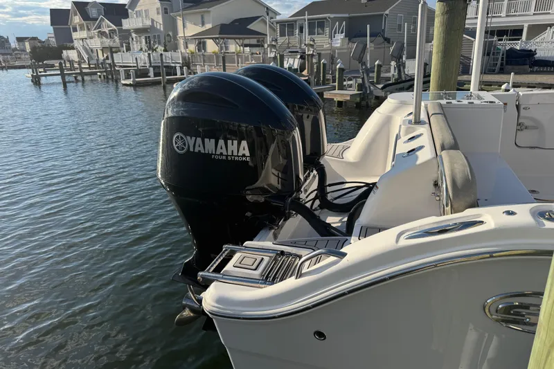 Slide: The Image of 2023 Sea Fox 268 Commander boat docked with dual Yamaha engines. - 9