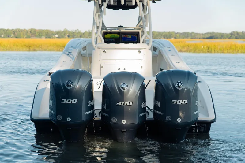 Slide: The Image of 2014 Yellowfin 34 Offshore boat with triple Yamaha 300 engines on water. - 10