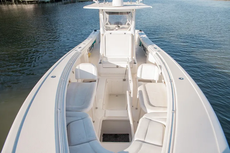 Slide: The Image of 2014 Yellowfin 34 Offshore boat with spacious seating on calm water. - 13